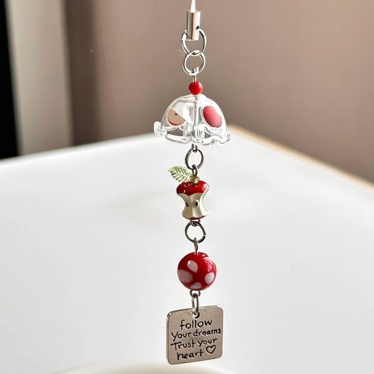 Red Apple Core Wind Chime Pendant Bring natural charm to your space with this delicate red apple core wind chime pendant