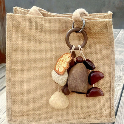 Forest-Inspired Handmade Nutshell Wind Chime Bag Charm Bring natural elegance to your everyday carry with this enchanting handmade bag charm