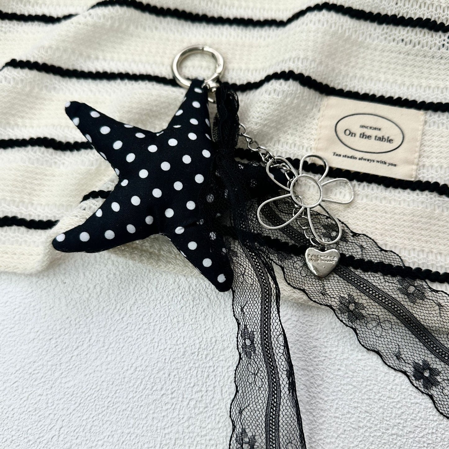 Vintage Canvas Bag Charm with Five-Pointed Star.Add a touch of retro charm to your everyday carry with this stylish fabric bag accessory